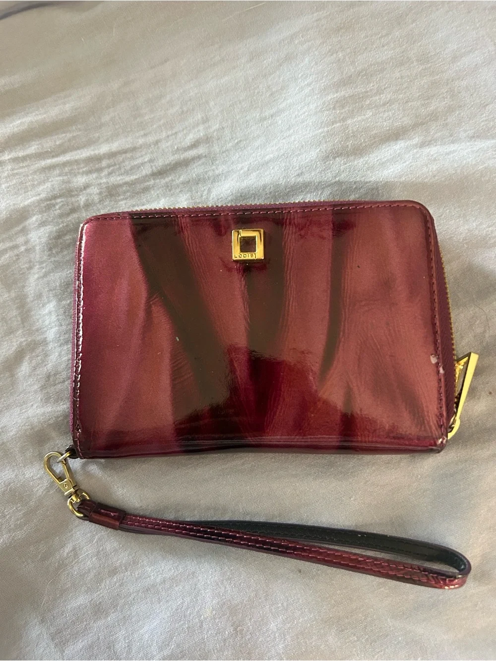 Hard to find patterned Patent Purple Wristlet Wallet with Gold Tone Hardware.